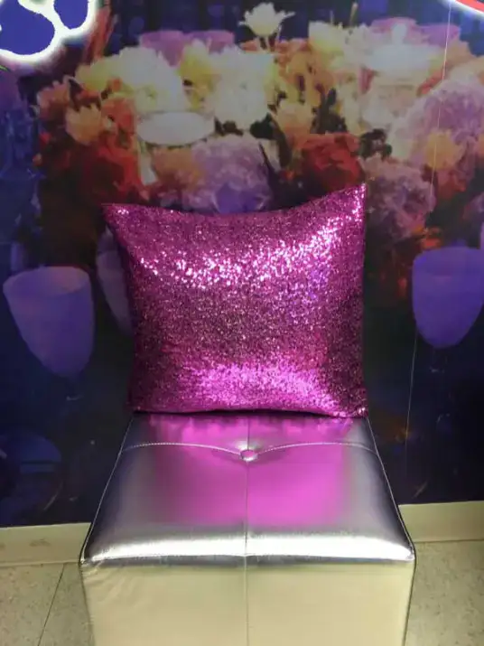 A shiny pink sequin pillow on a silver chair adds glam perfect for sweet sixteen parties in New York.