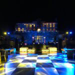 A glowing blue and yellow dance floor awaits at a premier New York & Long Island event venue.