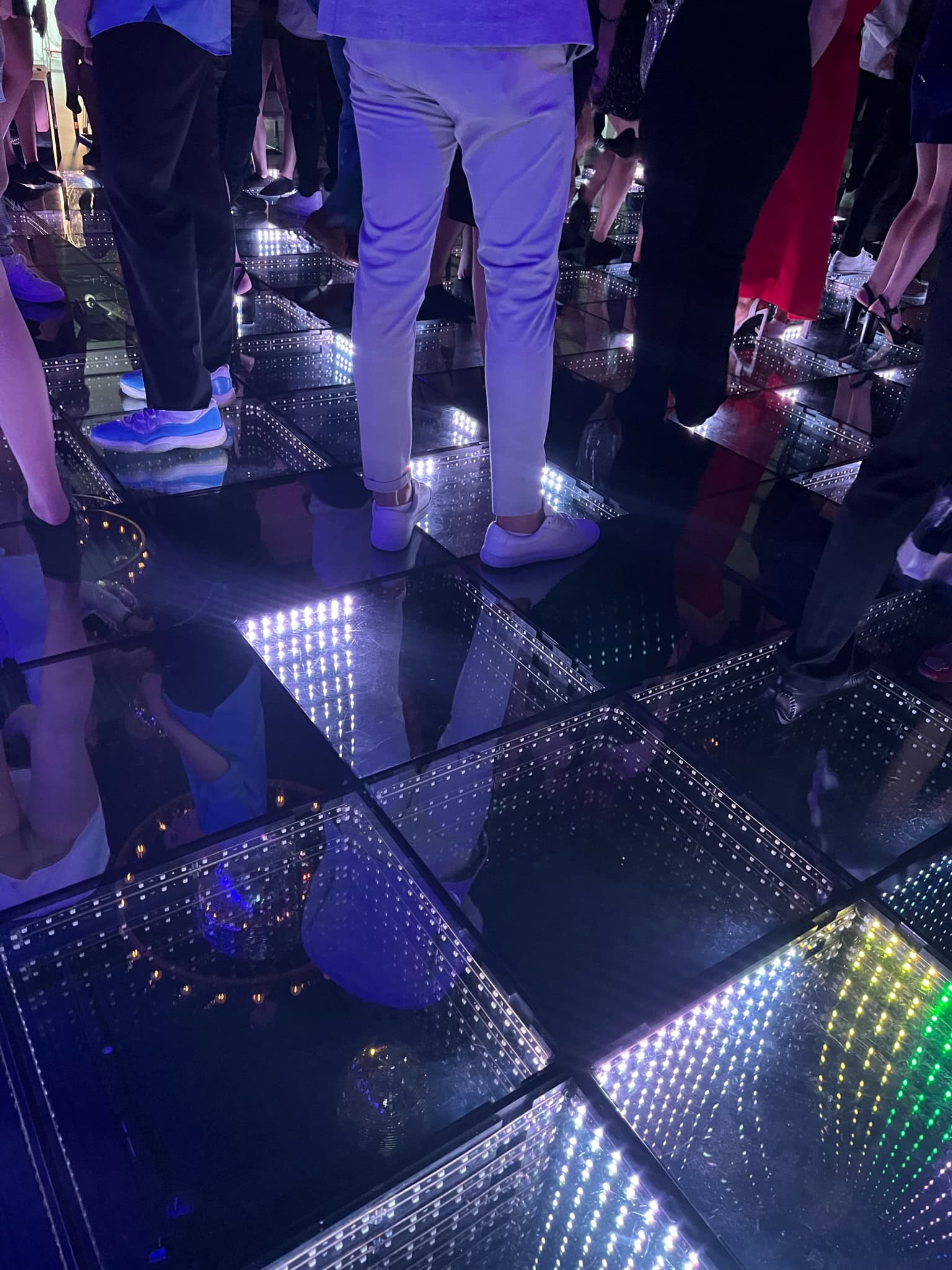 Teens dance on a glowing floor at a vibrant sweet sixteen in New York and Long Island celebration.